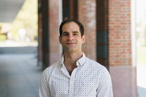 Adam Steel standing in a courtyard.