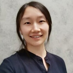 Head shot of Dr. Zhang against a white marble background