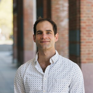 Adam Steel standing in a courtyard.