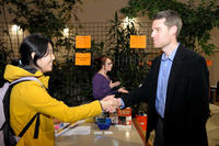 Student and alumni shaking hands