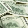 pile of $100 bills scattered