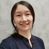 Head shot of Dr. Zhang against a white marble background