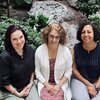 From left to right, Professors Tancredy, Travis, and Shenouda sitting together in front of the plants housed in the Psychology building atrium